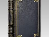 a black leather book with gold trimming and gold trimming