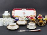 many different types of coffee cups and saucers on the table