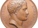 a close up of a coin with a man ' s head on it