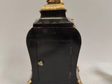 pair of antique black and gold clock stands on a white background