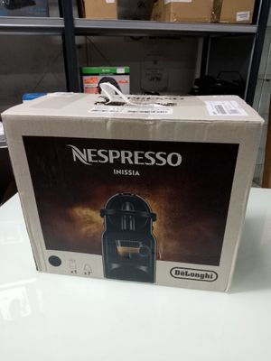 a box of nespresso coffee machine sitting on a table