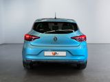 the rear end of a blue car in a white room