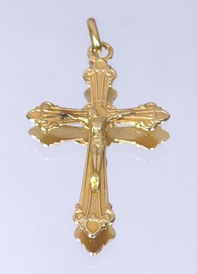 gold plated crucift with a cross on a white background