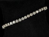 a diamond tennis bracelet on a black mannequin