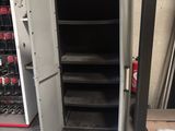 a metal cabinet that is open in a garage