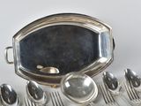 a lot of silver spoons and spoons on the table