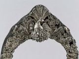 a silver ring with a bird on top of it