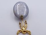 a picture of a necklace with a bird on it