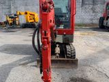 a red excavator that is sitting in the dirt