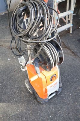 a machine that is sitting on the ground next to a ladder