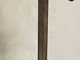 a tall metal pole with a top hat on it