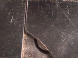 a piece of metal that has been scratched off and is sitting on a table