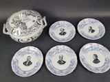 six blue and white plates and a bowl with a picture of a man on it
