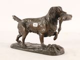 statue of a dog holding a bird in its mouth on a white background
