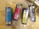 three different colored ink cartridges sitting on a table