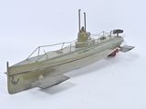 a model of a small boat on a white surface