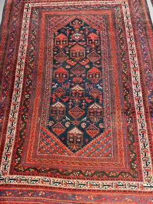 tapis persan ancien à motifs bleus et rouges