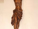 a statue of jesus hanging on the wall of a church