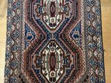 a rug on a wooden floor with a wooden floor in the background