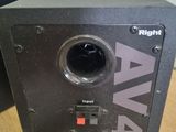 a close up of a black speaker on a wooden table