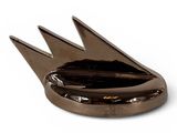silver plate with a bird shaped design on it on a white surface