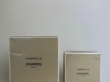 a white box with a bottle of perfume next to it