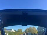 the back of a car with its trunk open and the back door open
