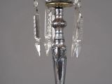 a silver candelab with a crystal candle holder on it