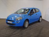 the small blue car is parked in a large room