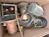 a box full of old copper pots and pans