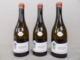 three bottles of wine are lined up on a table