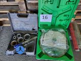 a green box with tools in it sitting on the floor