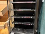 a black refrigerator that is next to a set of stairs