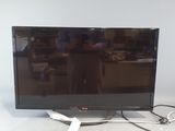 a flat screen tv sitting on a table with a cord