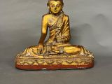 an image of a statue of a buddha sitting on top of a table