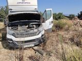 a white truck that has its hood open on the side of the road