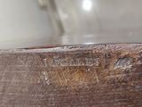 a close up view of a wooden bowl with a name on it