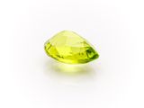 a yellow quartz faceted stone on a white background