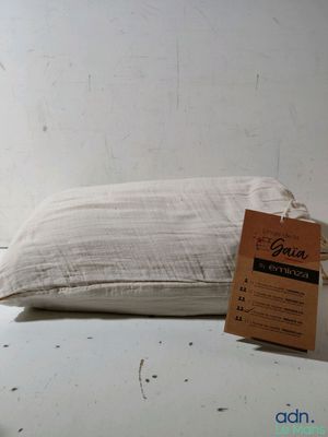 a pillow that has a tag on it on a table