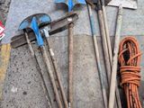 a pile of tools on the ground next to a fire hydrant