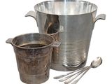 a silver bucket and a cup with spoons next to it