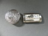 a small silver box with a picture of an elephant on it