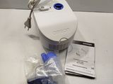 a white and blue device sitting on a white table
