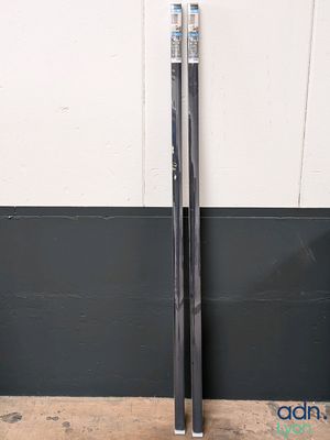 pair of skis leaning against a wall in front of a wall