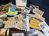 a lot of old postcards on a black table