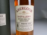 a bottle of whisky sitting next to a bottle of white oak