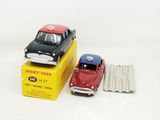 two toy cars that are sitting on top of a box