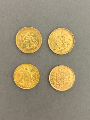 four gold coins with different designs on them on a gray surface