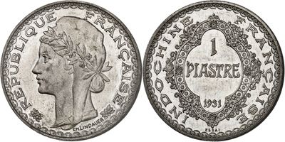 a silver coin with a woman ' s head and a crown on it
