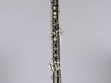 a close up of a clarinet on a clear surface